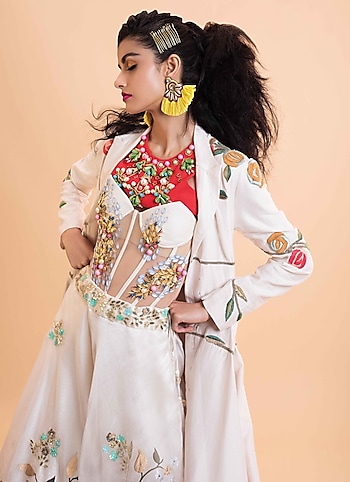 Channel a starry vibe as you sashay the next wedding party layering this corset & crop top by Papa Don't Preach with a statement Samant Chauhan jacket. Team it with a voluminous skirt by Devnaagri and add up a few statement pieces of jewellery by LADY LUXE